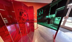 Transparent plexiglass panels stand in the gallery, with one green-tinted and one red-tinted folding screen, both etched with line drawings of Sora as a baby.