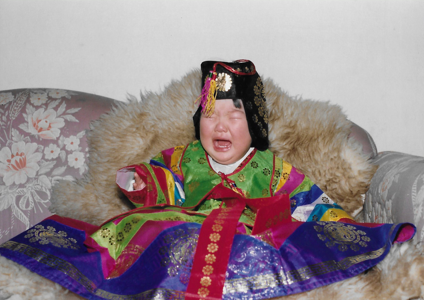 An archival family photo of Sora Park as an infant, crying, in traditional Korean garments.