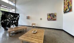 View of east wall with 3D works installed on the wall and two large bamboo seats in the centre of the gallery.