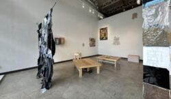 A view of a variety of works both on the ground, and on the wall during the group show, HOHOL