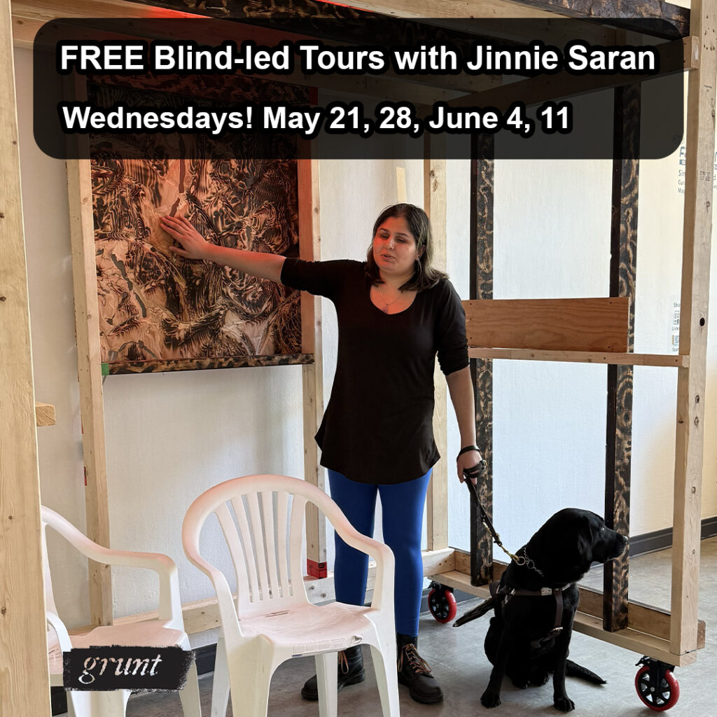 Inside grunt gallery, Jinnie, a young woman with light brown skin, stands in a large wooden structure resembling scaffolding, touching a carved and burnt wooden panel at left while holding the harness for her seated Black Labrador guide dog in her other hand. Two white plastic chairs are positioned in front of her. At top contained in a black text box, white sans-serif text aligned left, outlines the title and dates of the tour series. Aligned with the text, at bottom left, grunt’s logo appears in black.